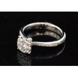 An contemporary hallmarked 18ct white gold diamond cluster ring,