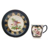 A late 18th Century Worcester coffee cup and saucer decorated with cartouche panels of 'Fancy