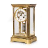 A 19th Century brass mantle clock with anchor escapement enclosed by bevelled glass sides and