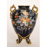 An early 20th Century Royal Crown Derby bombe shaped vase raised to four splayed feet,