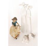 Three Lladro figures comprising a tall statuette modelled as two nuns, height 34cm,