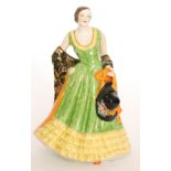 A 1930s Art Deco Plant Tuscan China model of a lady in Spanish dress holding a wide brimmed hat,