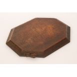 Robert 'Mouseman' Thompson - An oak breadboard of octagonal form, with adzed finish,