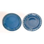 Ruskin Pottery - Two souffle glazed footed saucers each decorated in a mottle blue with a hand