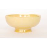 Ruskin Pottery - A miniature footed bowl decorated in an all over yellow lustre,
