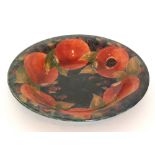 William Moorcroft - A large Pomegranate pattern shallow bowl decorated with a band of open and