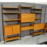 Robert Heal for Staples Ltd - A Ladderax teak modular wall system, comprising fall front cabinet,