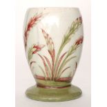 William Moorcroft - A 1930s footed vase decorated in the Waving Corn pattern with tubelined grasses