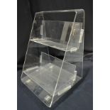 One Lux - A contemporary clear acrylic rolling book case, with 'Louis de Bernieres' label,