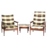 Guy Rogers - A pair of 'His and Hers' armchairs together with a matching foot stool from the