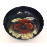 William Moorcroft - A large footed bowl decorated in the Pansy pattern with a large central