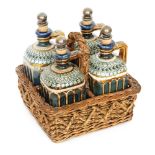 Doulton Lambeth - A set of four stoneware spirit flasks each of shouldered square section with