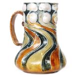Frank Butler - Doulton Lambeth - A flower jug decorated with tubelined wrythen lines glazed in