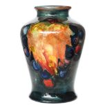 William Moorcroft - A small vase of inverted baluster form decorated in the Flambe Leaf and Berry