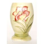 William Moorcroft - A small footed vase decorated in the Freesia pattern with tubelined sprays of