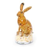 David Cleverly - A later 20th Century studio pottery model of a hare decorated in a treacle glaze
