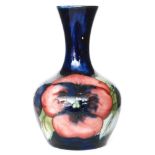William Moorcroft - A small vase of globe and shaft form decorated in the Pansy pattern on blue