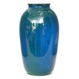 Ruskin Pottery - A barrel vase decorated in an all over green and blue souffle glaze with a painted