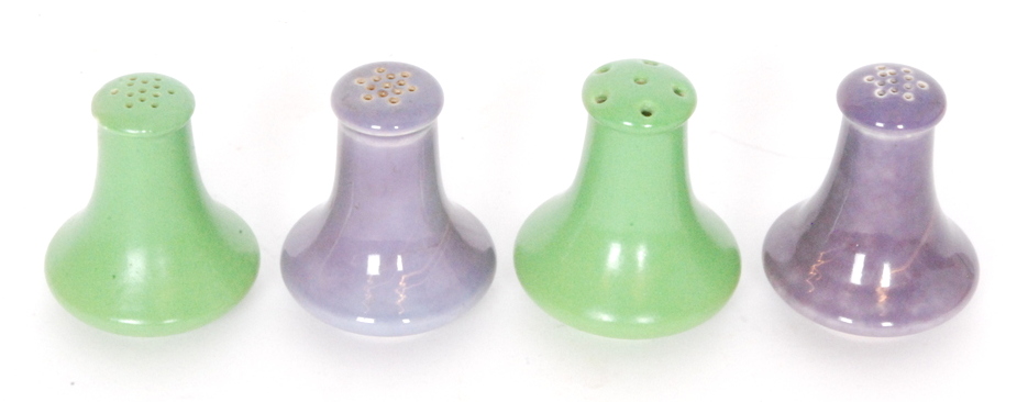 Ruskin Pottery - Four similarly shaped pepper pots comprising two glazed in a lavender lustre and