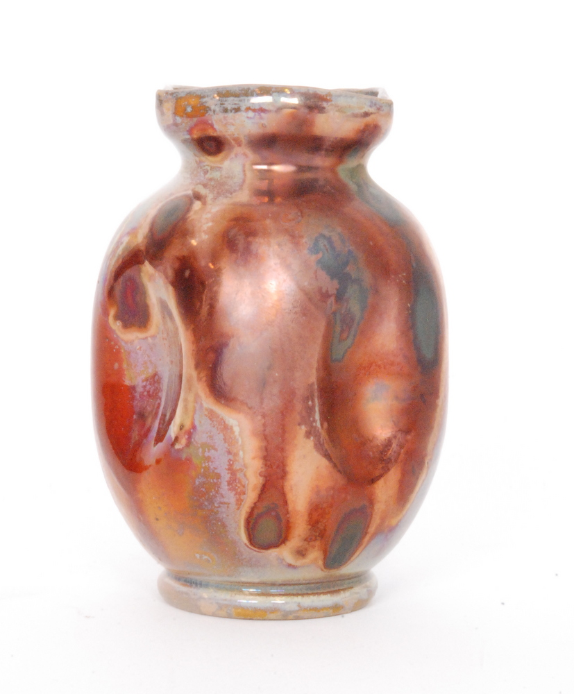 Unknown - An early 20th Century ruby lustre vase of barrel form with indented oval panels to the