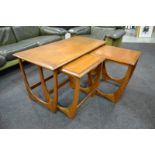 G-Plan Furniture - A nest of three model 8041 teak occasional tables on loop style supports.