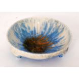 Ruskin Pottery - A small crystalline glaze tri-footed bowl decorated with a mottled blue over white