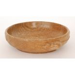 Robert 'Mouseman' Thompson - An oak bowl of circular form, in an adzed finish,