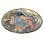 William Moorcroft - Liberty & Co - A shallow dish decorated in the Claremont pattern with four