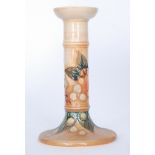 A Moorcroft Pottery candlestick decorated in the Finches pattern designed by Sally Tuffin with