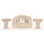 An Art Deco French clock garniture in speckled and silvered height lighted case,