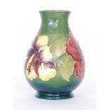 A Moorcroft baluster vase decorated in the Hibiscus pattern with a crimson and a yellow and