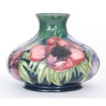 A Moorcroft Pottery vase of compressed form decorated in the Anemone Tribute designed by Emma