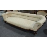 A William IV mahogany framed sofa with roll arms above squat reeded front legs,