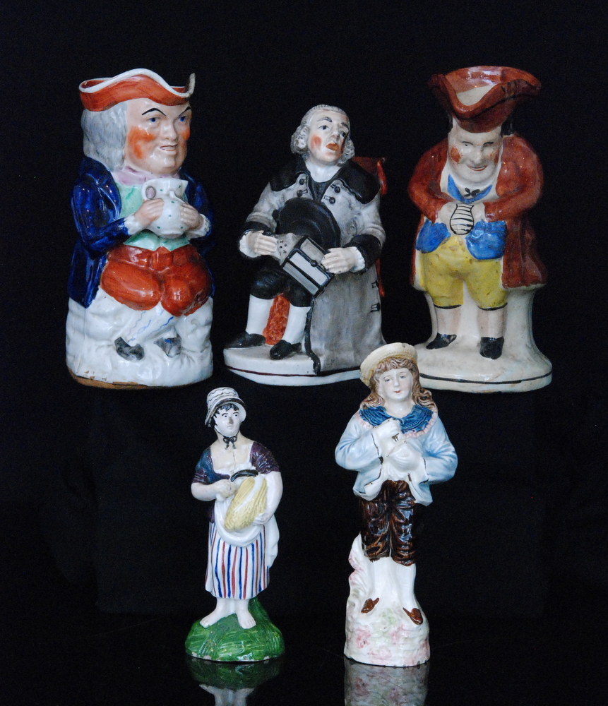 A 19th Century Enoch Wood type jug modelled as a seated Watchman holding out his lantern and sat on