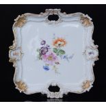 A late 19th to early 20th Century Meissen twin handled square tray decorated with a spray of hand