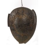 A late 19th Century oval ceremonial shield embossed and chased on gilt metal depicting a battle