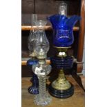 A Victorian brass oil lamp with blue shade and reservoir and two similar smaller oil lamps (3)