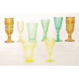 A collection of 19th Century and later pressed glass celery vases with foliate and geometric