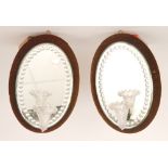 A opair of late 19th Century Stourbridge girondale wall mirrors of oval section mounted with a