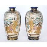 A pair of late 19th to early 20th Century Japanese Satsuma vases each panel decorated with scenes