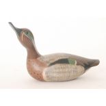 William Porterfield - A carved wooden decoy Teal duck with neck raised and painted finish,