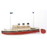A JEP three funnel liner cream deck black and red painted hull with twin masts and flags,