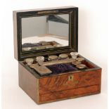 A Victorian figured walnut dressing table box with mirrored lid interior and fitted with an