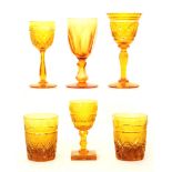 A pair of late 19th Century golden amber glass tumblers with diamond and fan cut motif,