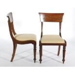 A set of four William IV mahogany bar back dining chairs on reeded front legs and slip in gold