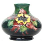 A small Moorcroft vase of compressed form decorated in the Columbine pattern with two tubelined