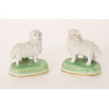 A pair of Dresden encrusted lambs both stood on green oval bases, printed Dresden mark, length 5.
