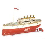 A Carette four funnel liner with single mast, lithographed port holes, cream and red hull,