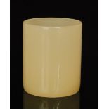 A late 19th to early 20th Century white jade beaker of cylindrical form,