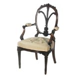 An early 20th Century mahogany balloon back open armchair Prince of Wales feathers central splat,